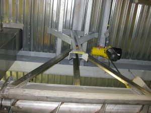 Hoist attached to conveyor